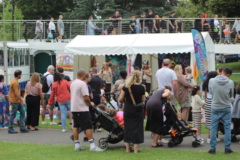 Crowd of adults and children in front of small stage with children performing