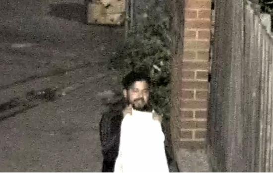 Male dressed in black holding white mattress in front of his body