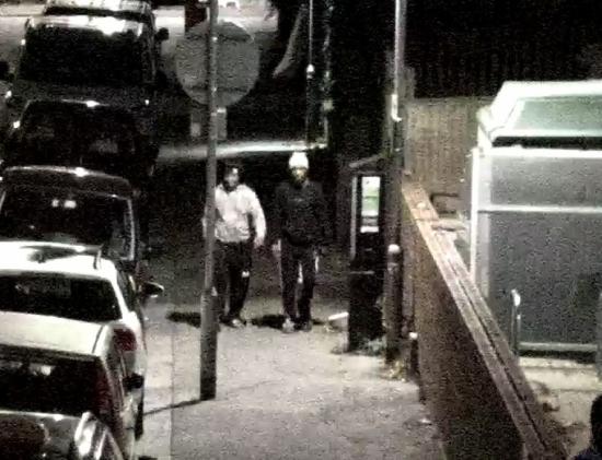 Two males walking on pavement