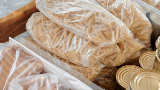 Food package showing pasta, bread and tinned goods