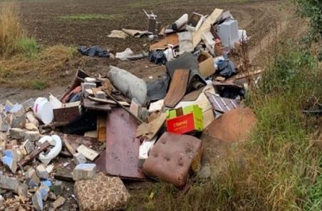 A mix of rubbish fly-tipped in a field