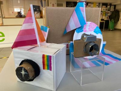 Two pieces from The Higgins Bedford's LGBT+ History Month exhibition. Two cameras made from cardboard with flags