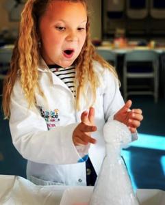 Child discovering science experiment with bubbles