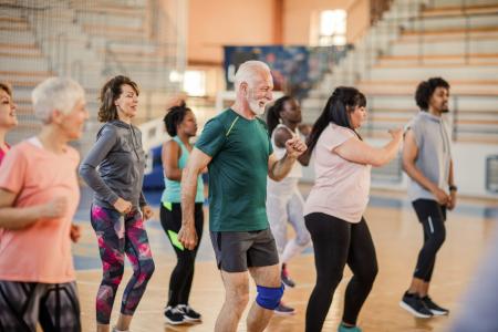 An image of people with a range of ages taking part in gentle exercises