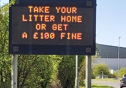 Roadside notice with "Take your litter home or get a £100 fine"