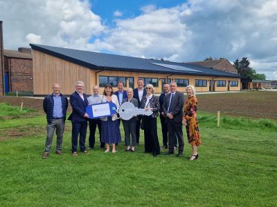 Biddenham school new buildings with representatives from organisations standing outside new ICT block