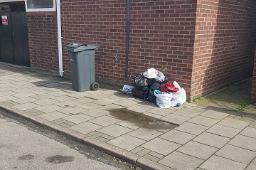 Bags of rubbish piled on the pavement