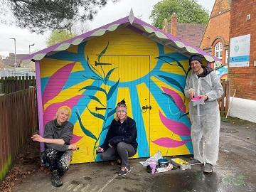 The new shed, and the creative team, outside Pine Cones Family Hub