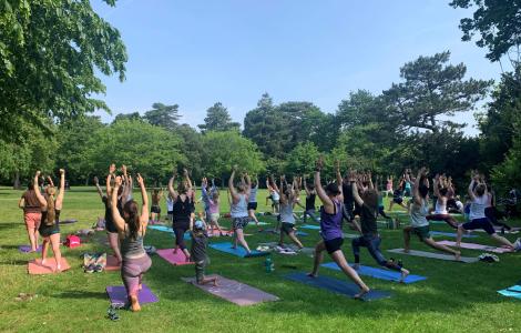 Large group of people doing Yoga in Bedford Park