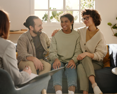 Adult male and female with teenage child sat between them