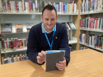 A member of the Bedford Borough Libraries team enjoys a digital book