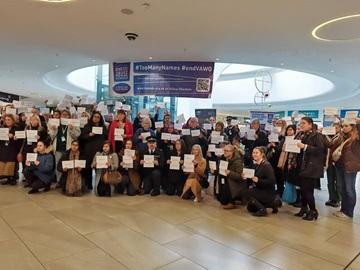 People with signs at TooManyNames 2024 