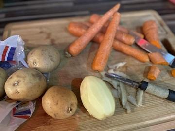 Potatoes and carrots on a chopping board