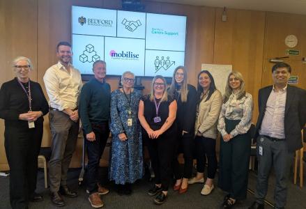 Staff and partners line up to celebrate the new partnership