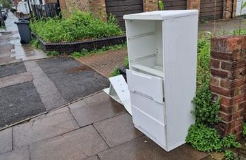 A broken cupboard on the street - fly-tipping