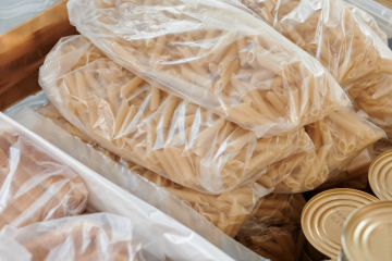 Food package showing pasta, bread and tinned goods