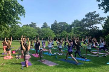 Large group of people doing Yoga in Bedford Park