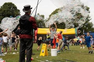 Bubble man creating bubbles in a park