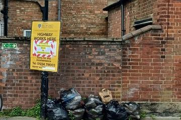 Fly-tipping of bin bags on a street