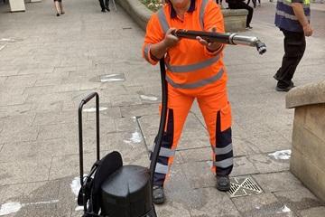 Cllr Gribble removing chewing gum from the pavement