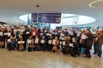 People with signs at TooManyNames 2024 