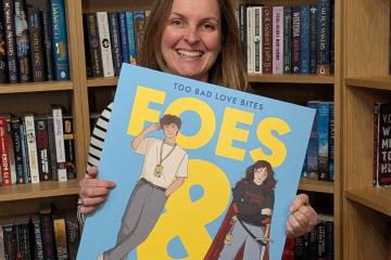 Georgia Bowers with a (giant-sized) edition of her book
