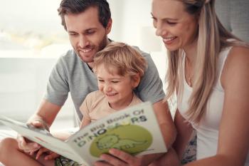 Man and woman with child and open book