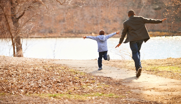 Boy and man playing outside