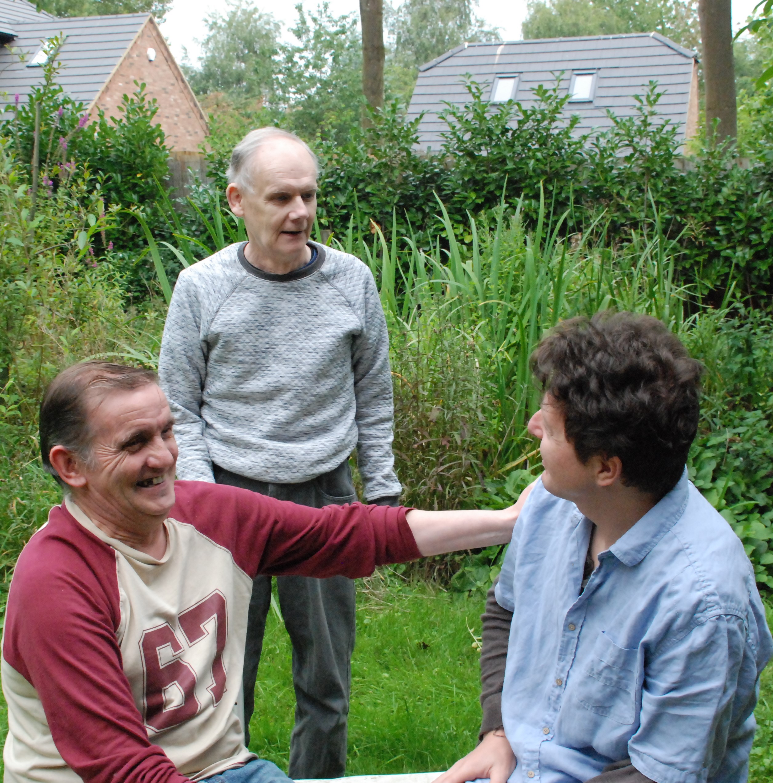 Three people in a garden